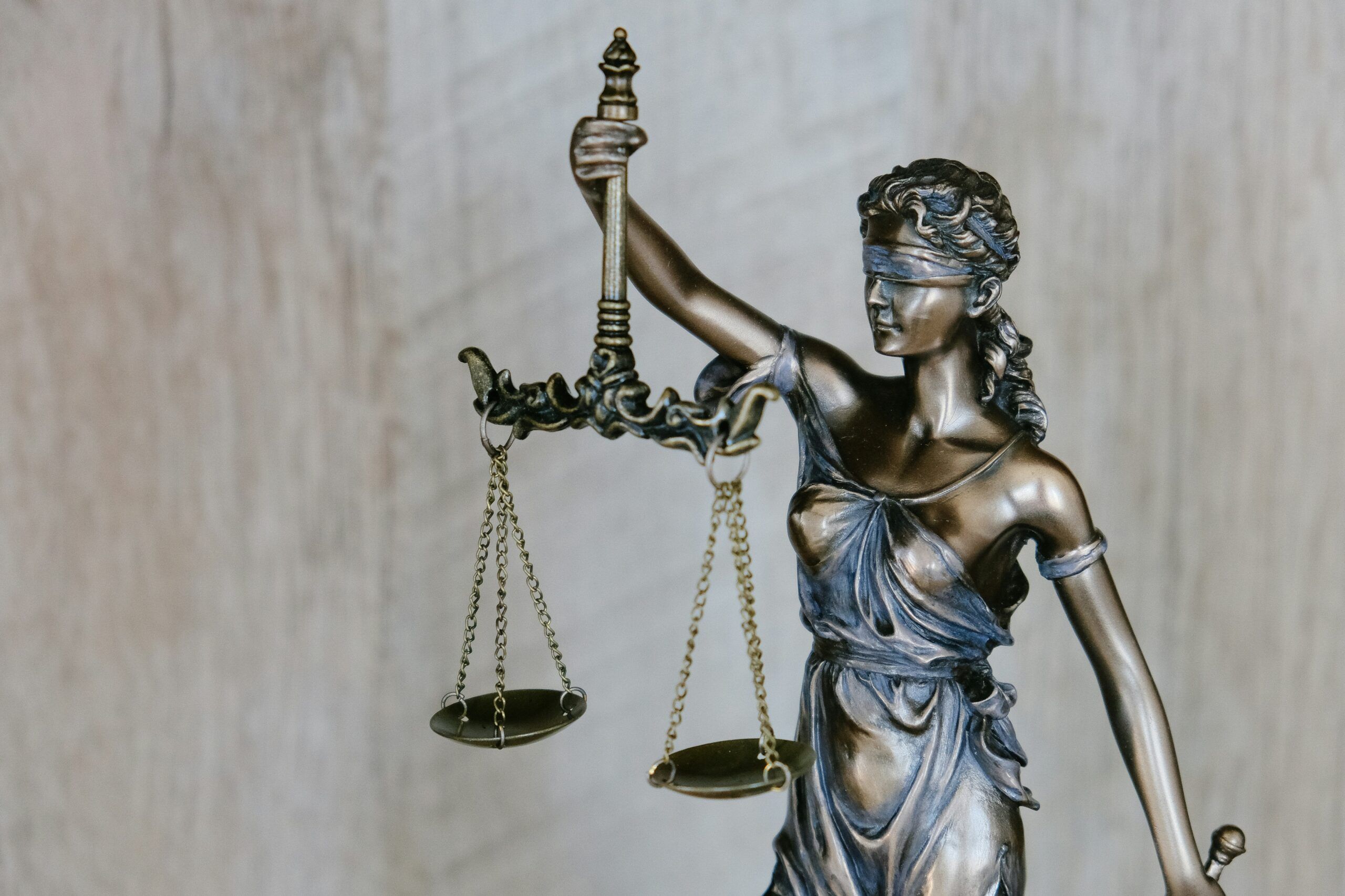 closeup-of-small-statue-of-lady-justice-holding-up-a-scale